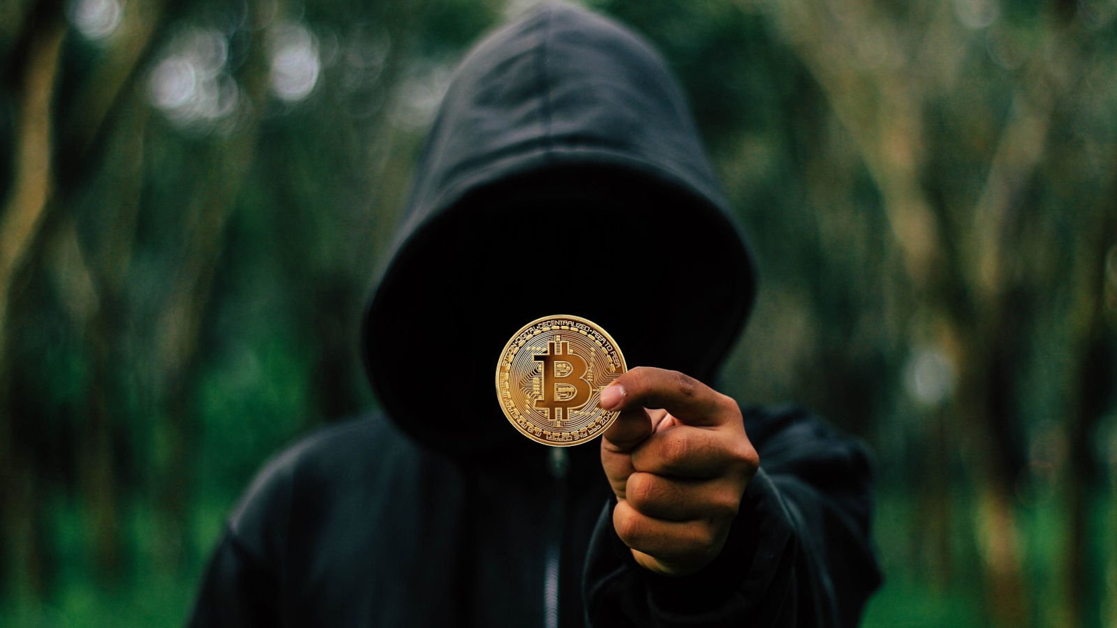 Hacker holding a bitcoin